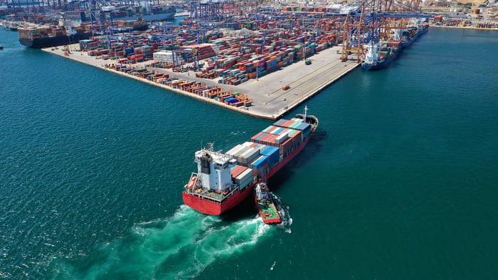 Shipping port with cranes and containers, highlighting the importance of reliable data and analytics for assessing severe weather impacts.