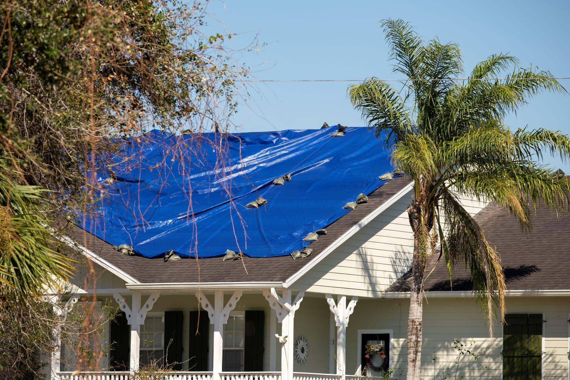 damaged-in-hurricane-house-roof-covered-with-blue-2024-12-06-05-01-07-utc